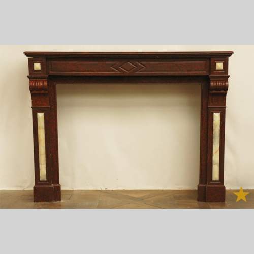 Камин из красного мрамора гриот и вставками из оникса.